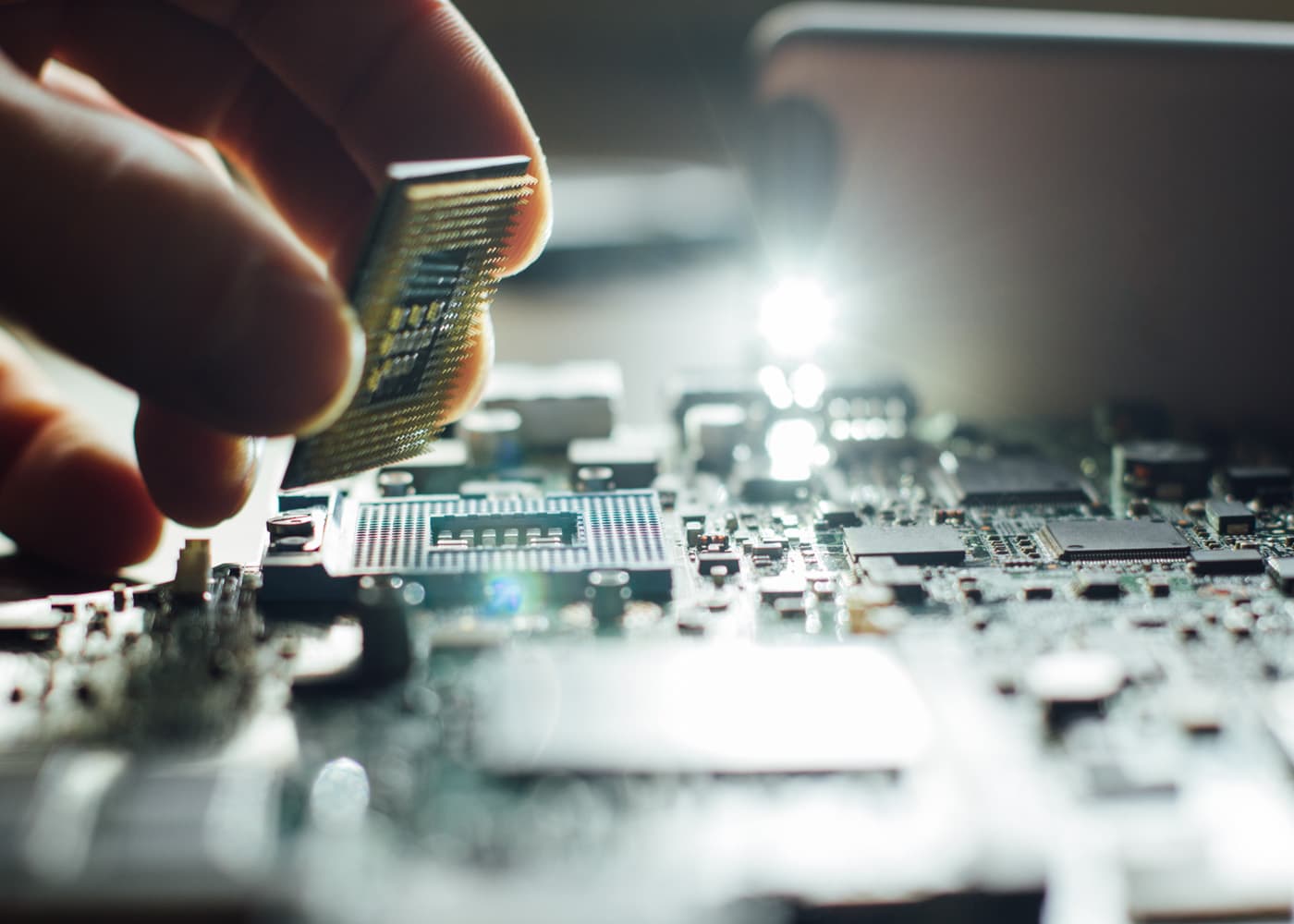 electrical-img placing chip into motherboard